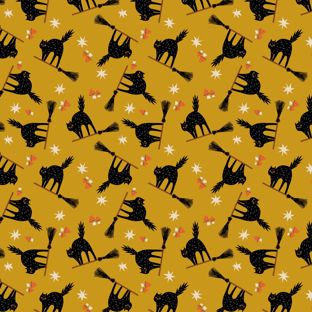 Witchy cats flying on witch's broomsticks on a gold background.